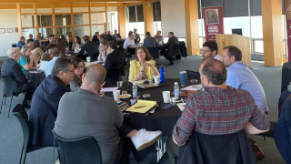 a photo of a group of people sitting and working together