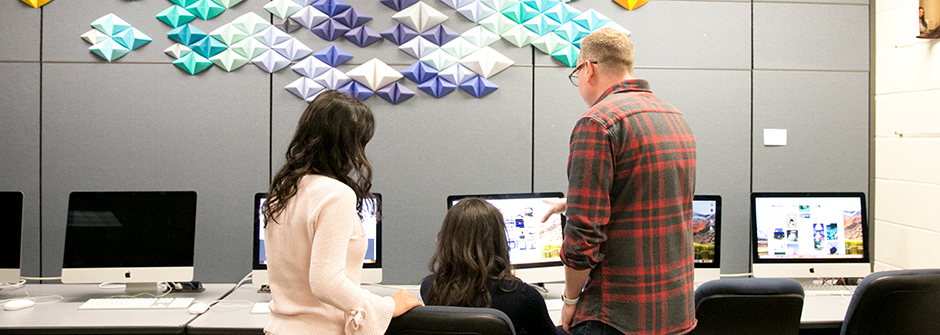 Students with a professor in a design class.