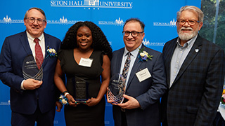 A photo of honorees David Adinaro, Debeka Bennett, and Daniel Katz.Dean Joseph J. Martinelli speaking at alumni reception.Dean Joseph J. Martinelli with the Hanbury and Schreitmueller Honorees.