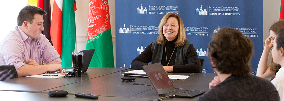 Diplomacy Graduate Students at a conference table.