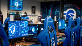 Esports lab with Pirates branded chairs and screens.