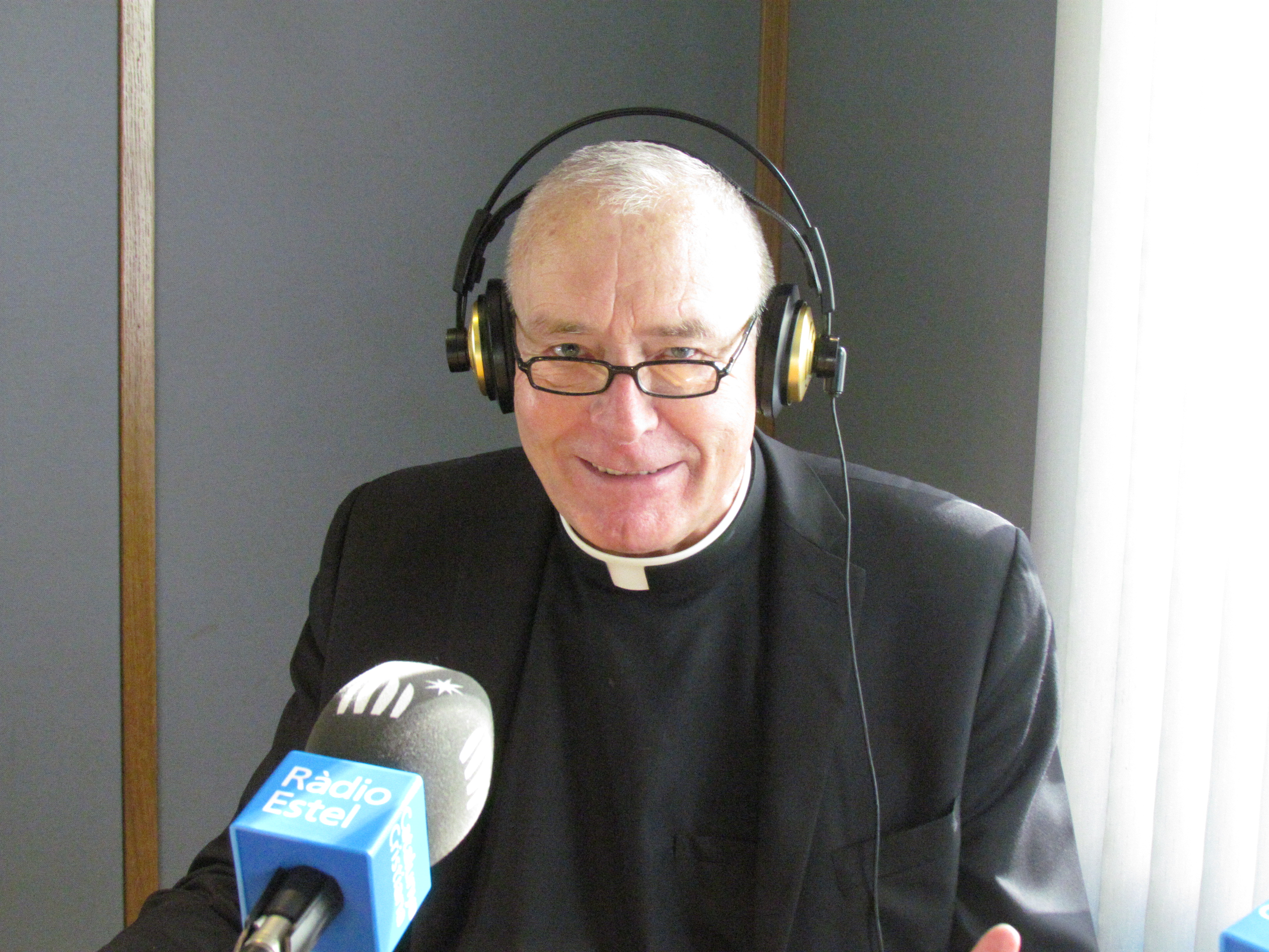 Father Boyd wearing headphones