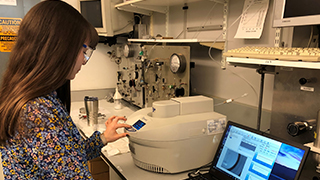 A chemistry student operating a microwave reactor for research. x320