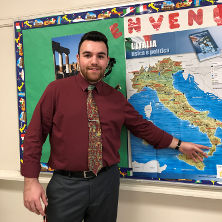 Eric Lavin pointing to Italy on a map.