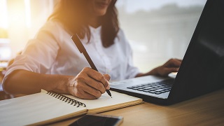 Young Woman Researching Investing Strategies 