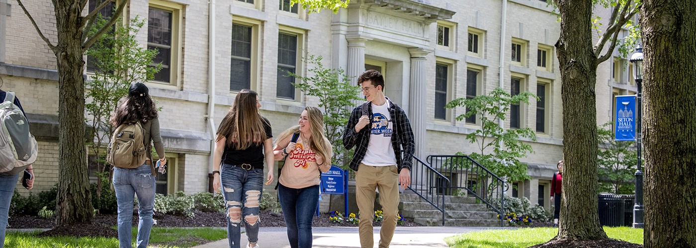 Students walking on campus in the summer