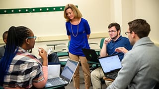 Associate Dean Leigh Onimus, J.D., with students in a Stillman classroom