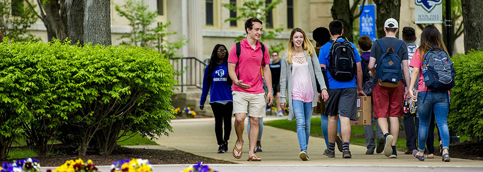 Students walking across campus in the spring.