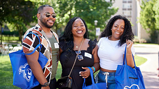 Alumni with Pirate swag bags are Alumni Reunion Weekend.
