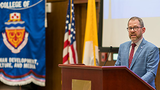 professor speaking on a podium 