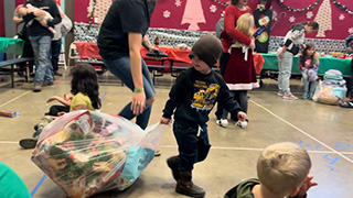 child with toy drive presents 