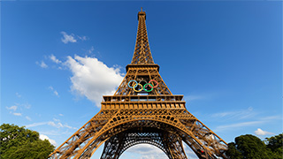 Olympics Logo with a backdrop of the Eiffel Tower