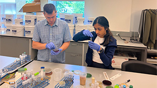 Hill and Aastha working in the lab.