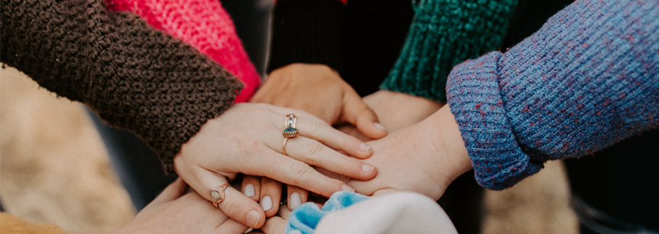 Image of multi-cultural hands joining together. 