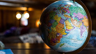 A photo of a globe, surrounded by landmarks. 