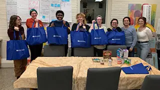 Graduate students donating to a food pantry.