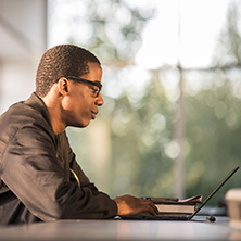 Grad Student Working on a Laptop