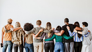 People standing in a row with their backs to us.