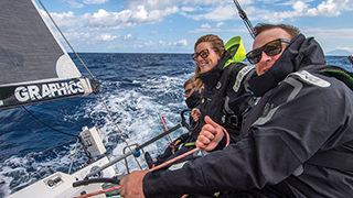 Meg Reilly with crew members out on the water sailing.