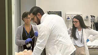 Three people practicing intubation