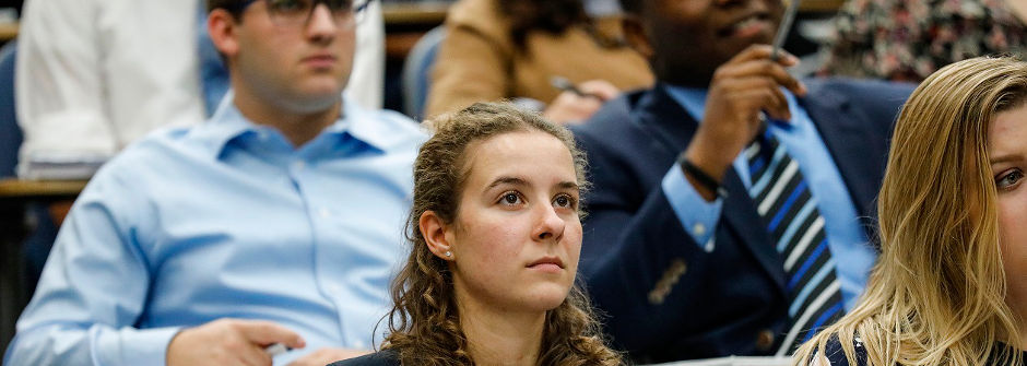 Students taking notes in class. 