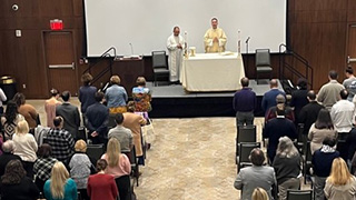 Attendees gather to celebrate midday Mass with Fr. Joseph Laracy. 