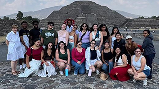 Students gathered in front of a pyramid in Puebla, Mexico