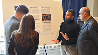 Rev. Pritchett watching a poster presentation.