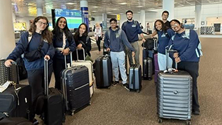 Students with their luggage at the airport.