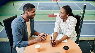An advisor talking to a sports player.