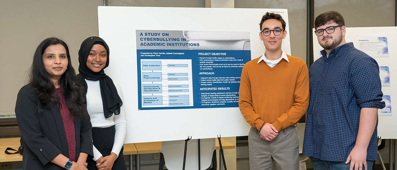 Students presenting their research at a poster session.