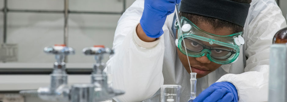 Student working with equipment in lab. 