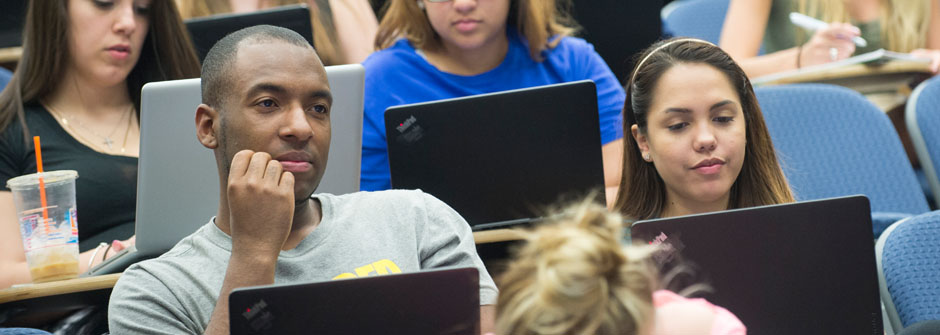 student in class on laptop