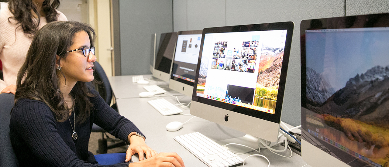 A student working on a design project on a computer.