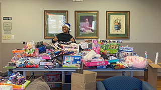 student with toy drive items 