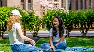 students sitting outside