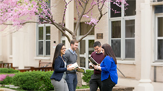 students speaking in front of fahy hall 