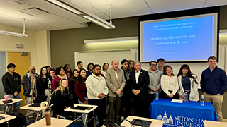 Students pose for a photo with New Jersey State Senators Jon Bramnick and Joe Cryan