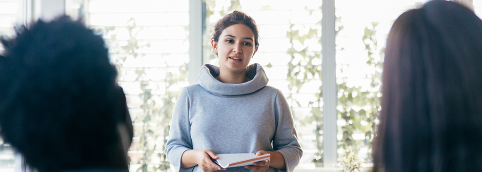 Student presenting in front of a window